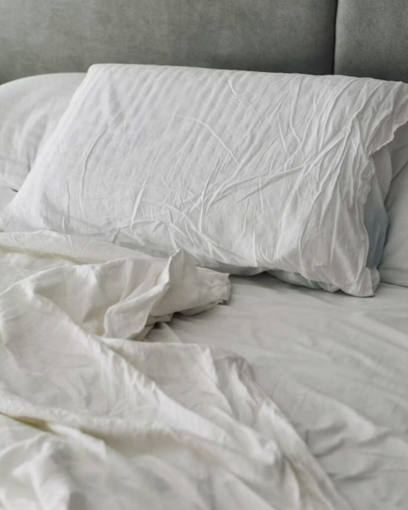 Warm neutral color palette in a small bedroom with beige bedding