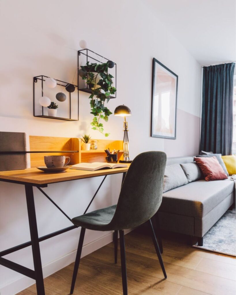 Slim console table placed behind sofa for storage in small living room