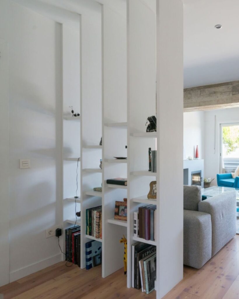 bookshelf divider separating zones in studio apartment